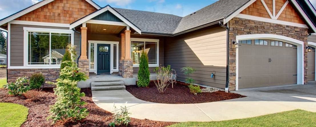 Beautiful new home with new plants in front.
