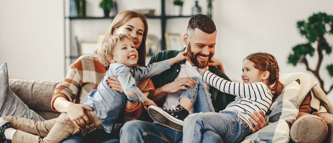 Happy family on the couch at home.