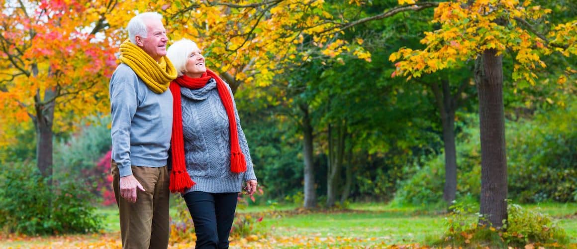 Older couple walking in autumn.