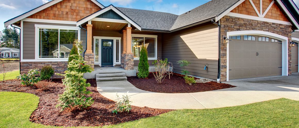 Beautiful new home with new plants in front.