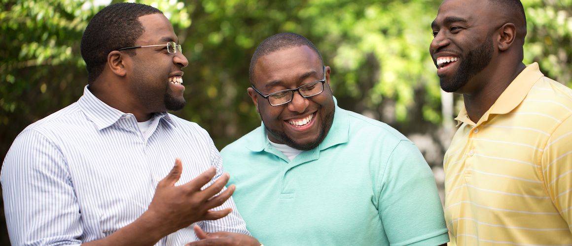 Brothers laughing together outside.
