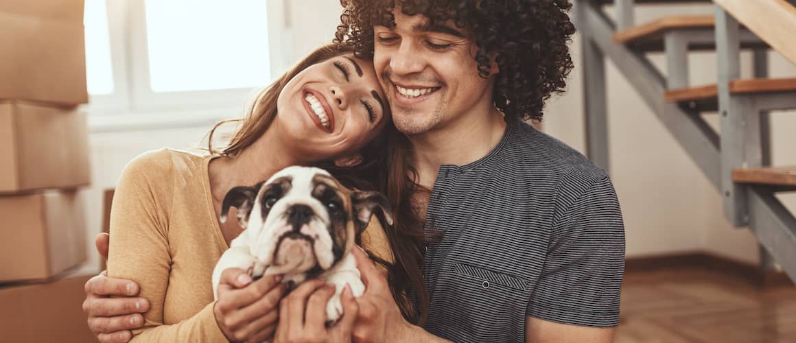 Couple with dog moving into new home.