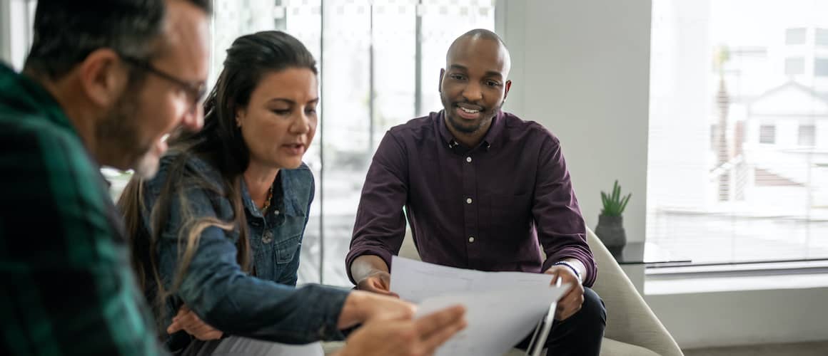 Casual Meeting Of Diverse Business Team Analyzing Financial Data