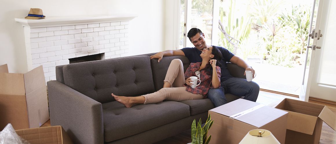 Couple on a sofa relaxing after a day of moving.