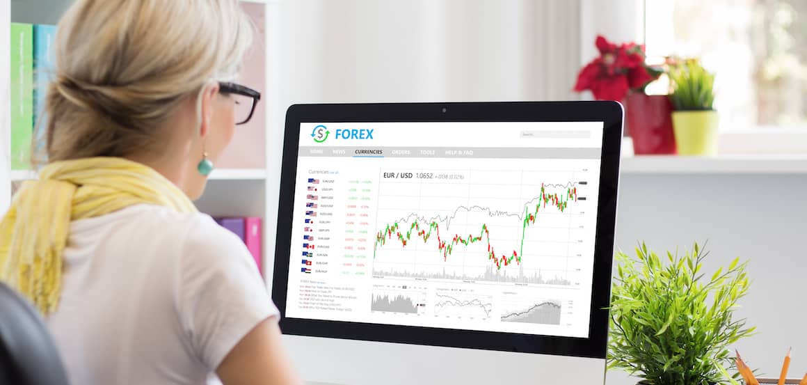 woman looking at forex on desktop