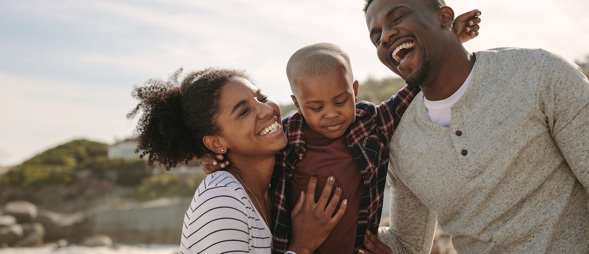 Happy family outside on the beach.