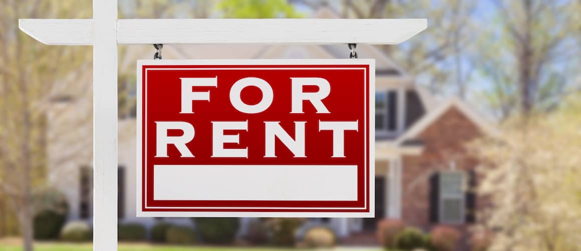 Large for rent sign in front of a house.