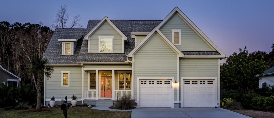 Pale green home at dusk.