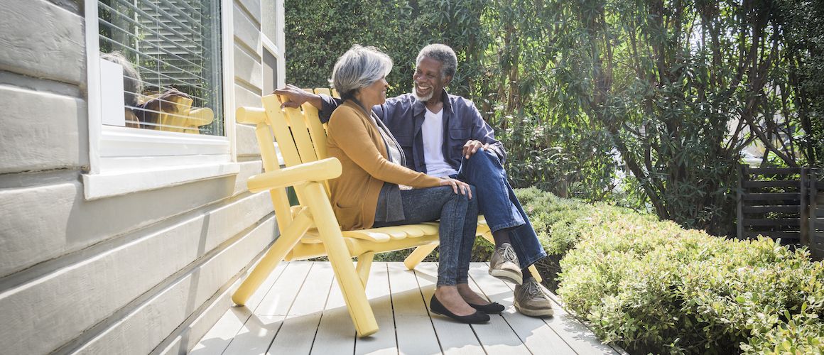 Senior couple sitting on a porch.