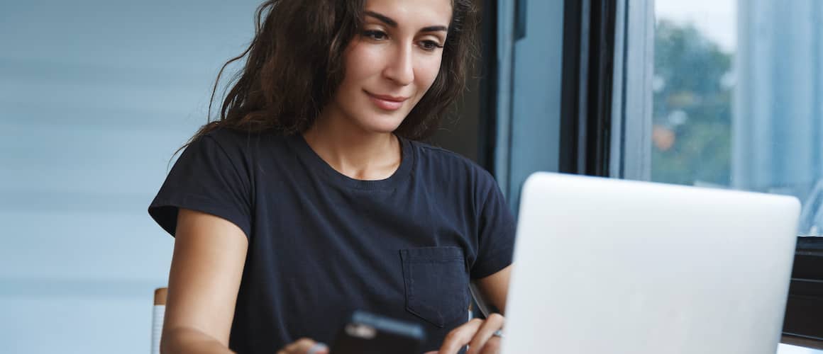 Woman reviewing her overall debt online.