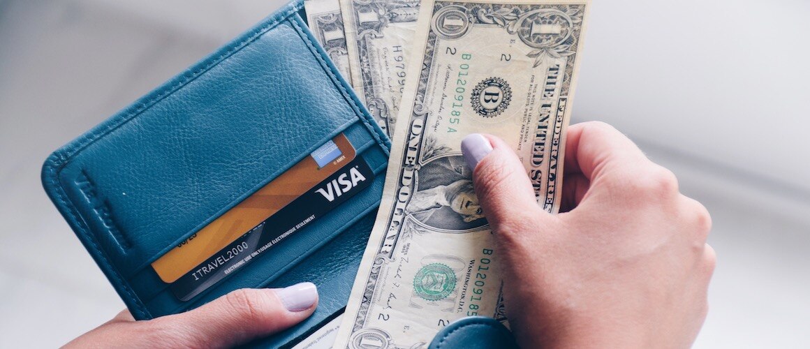 Woman holding wallet.