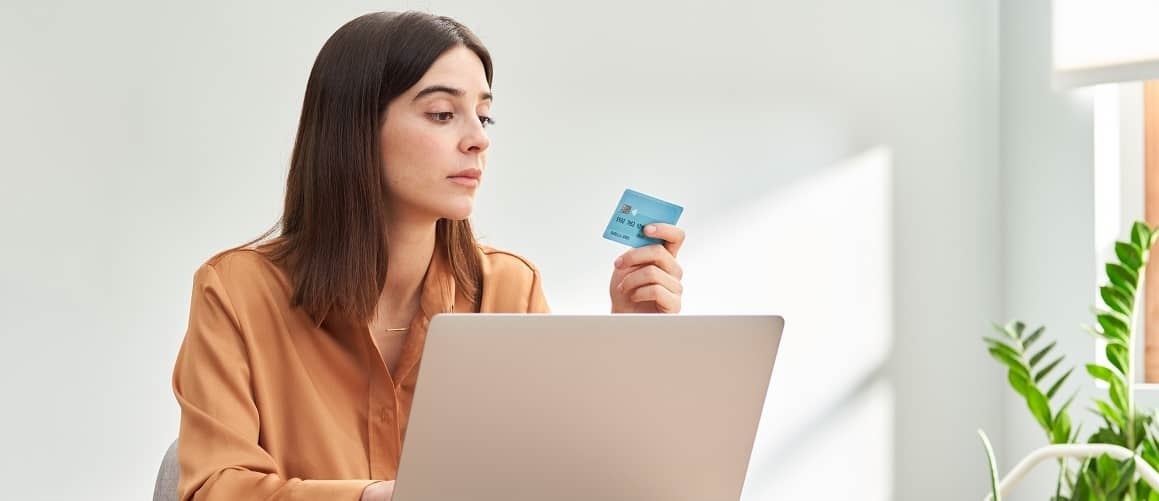 woman looking at credit card