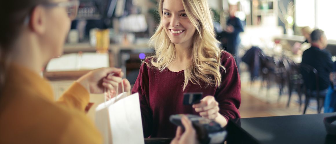 Woman cashing out at a shop.
