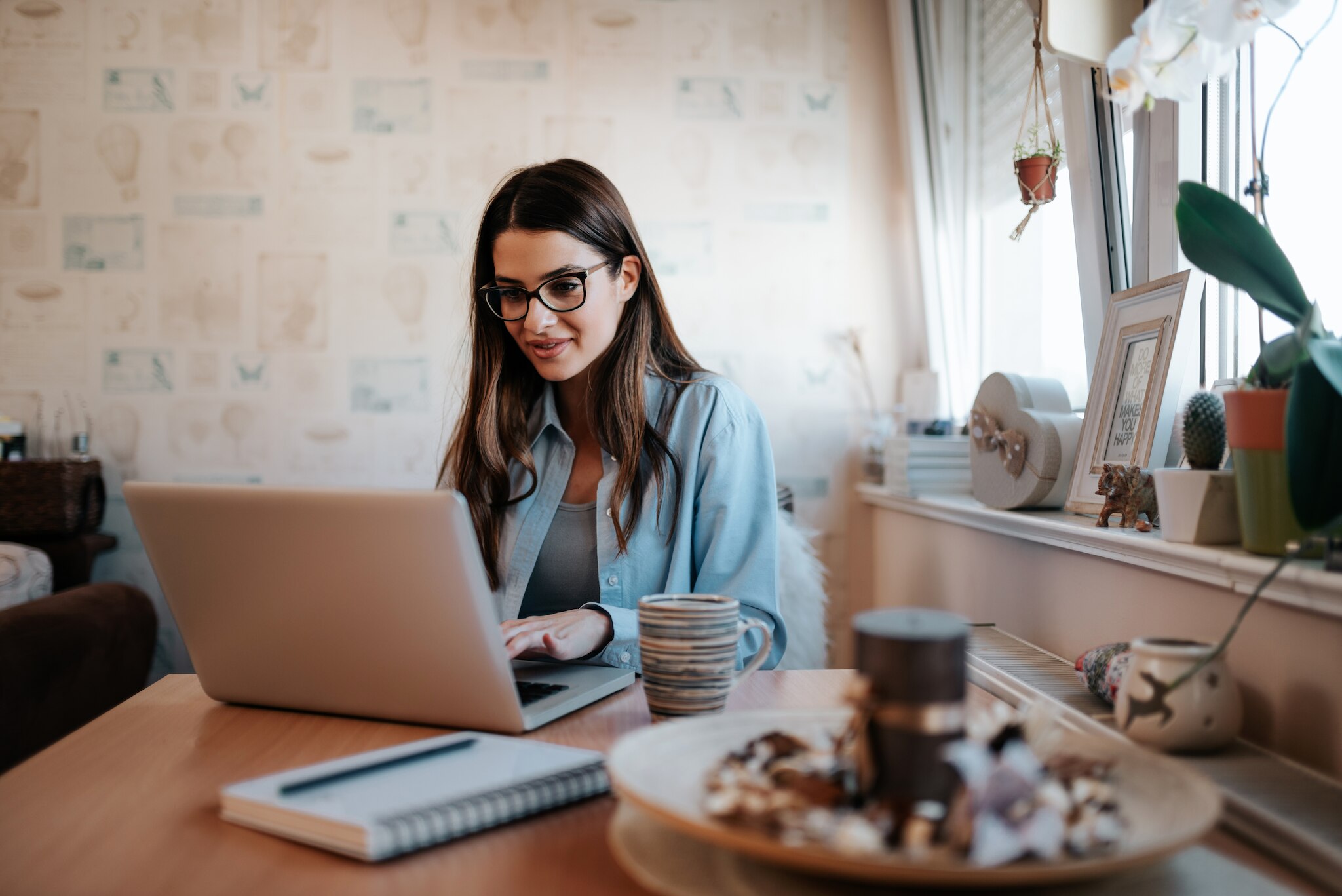 Woman using a laptop at home.