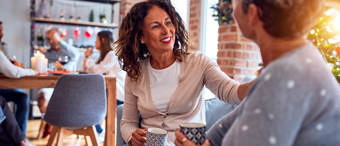 Women drinking coffee together at holiday time.