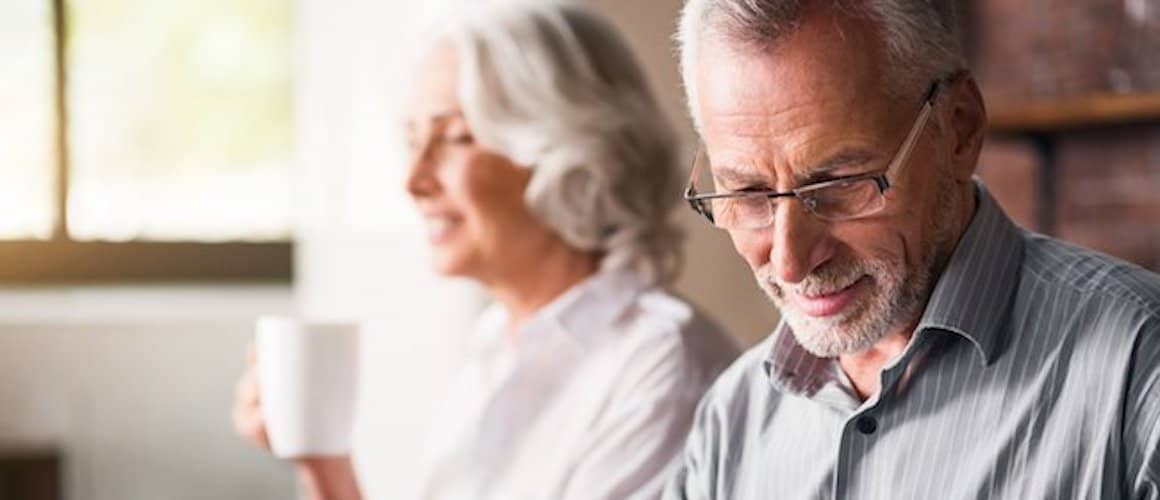 Older couple sitting together at home.