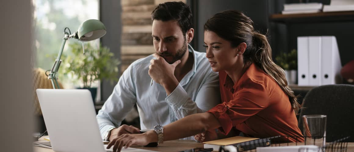 man and woman on laptop in coffee shop