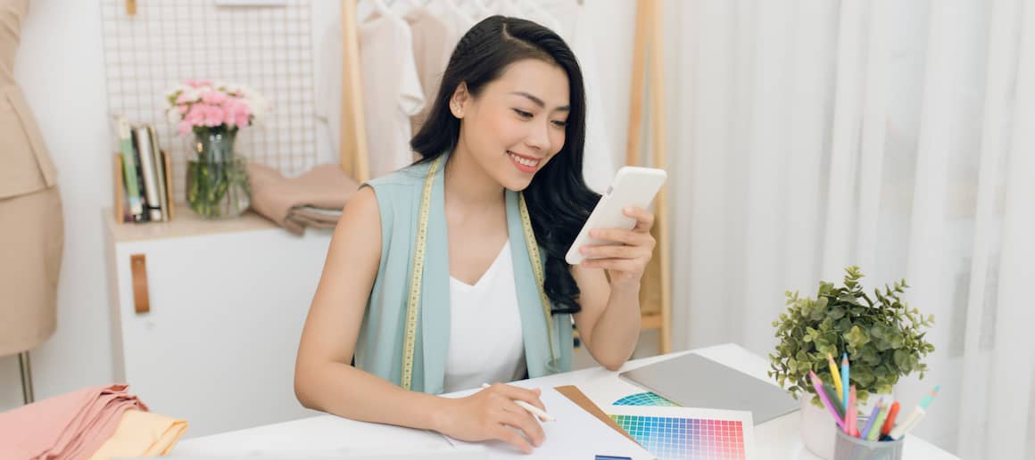 business owner in her shop on her phone