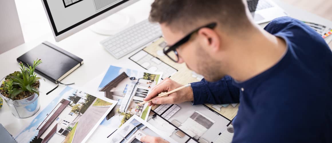 man with glasses sorting through house images